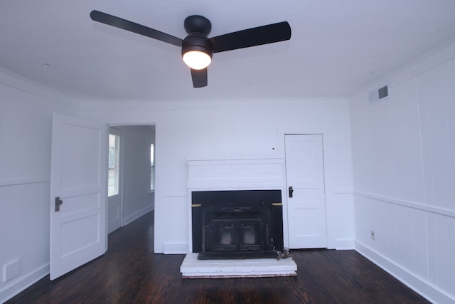 unfurnished living room with dark hardwood / wood-style floors, ceiling fan, ornamental molding, and a wood stove