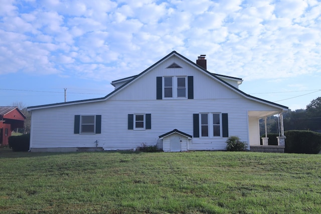 60 Riddle Rd, Shelbyville, TN 37160 - back of property with a lawn, a chimney, and covered porch