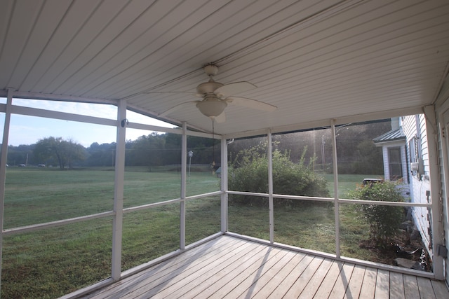 unfurnished sunroom with ceiling fan