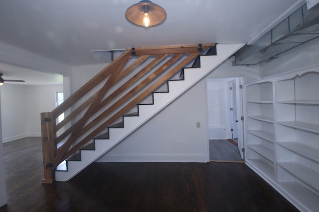 staircase with hardwood / wood-style flooring and ceiling fan