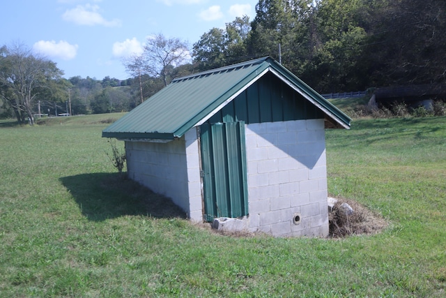 view of outbuilding with a yard