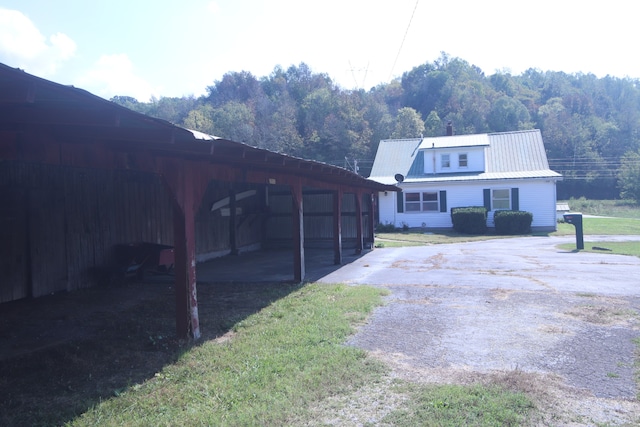 back of property featuring a yard and a carport