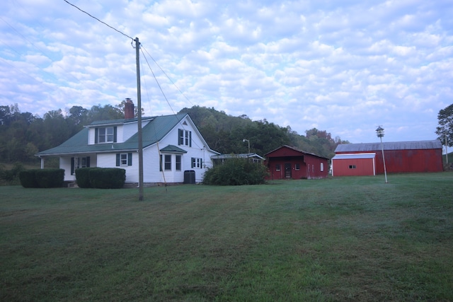 exterior space featuring an outbuilding, central air condition unit, and a lawn