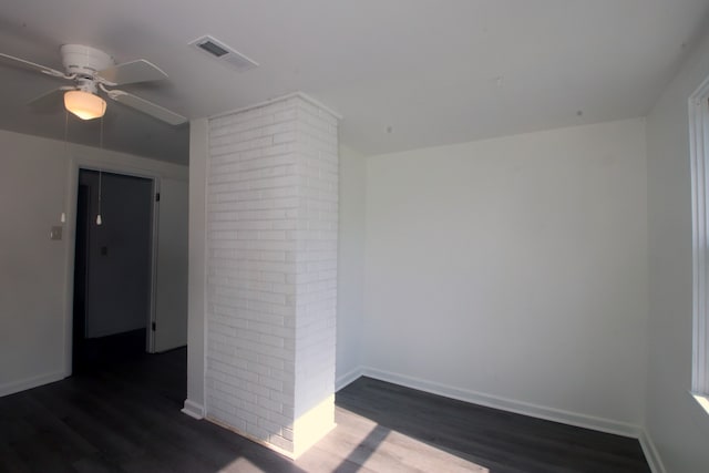 empty room with ceiling fan and dark wood-type flooring