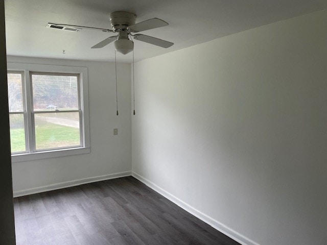 unfurnished room featuring ceiling fan and dark hardwood / wood-style flooring