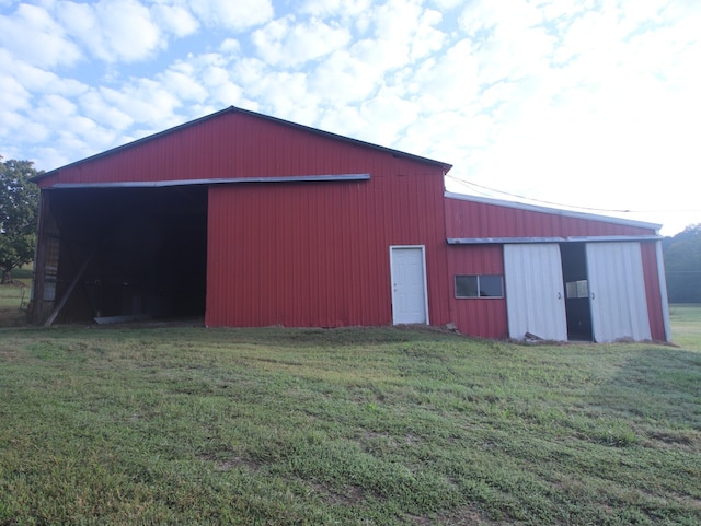 view of outbuilding featuring a yard