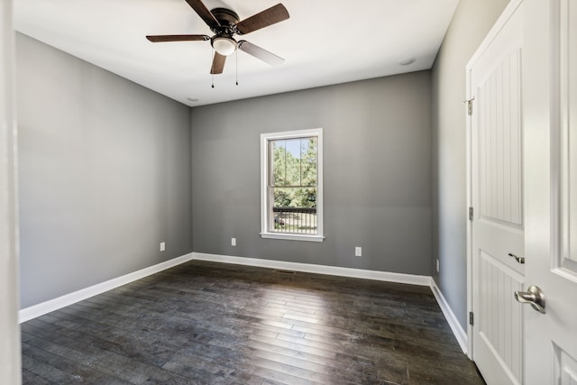 unfurnished room with ceiling fan and dark hardwood / wood-style flooring