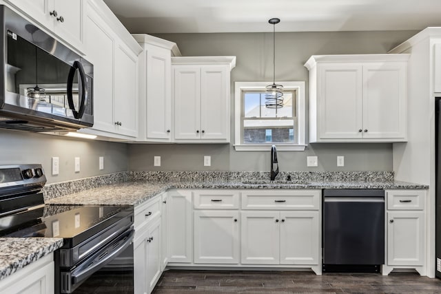 kitchen featuring white cabinets, sink, appliances with stainless steel finishes, dark hardwood / wood-style floors, and light stone counters