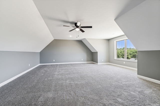 bonus room with carpet floors, vaulted ceiling, and ceiling fan