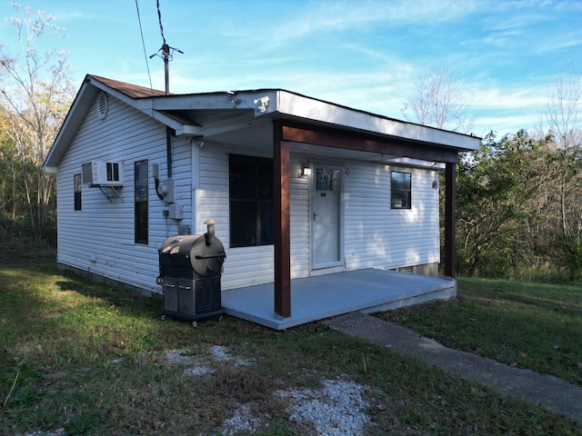 back of house with a lawn