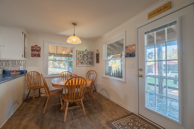 dining room featuring hardwood / wood-style flooring and crown molding