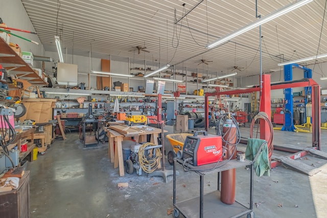 garage with a workshop area and ceiling fan