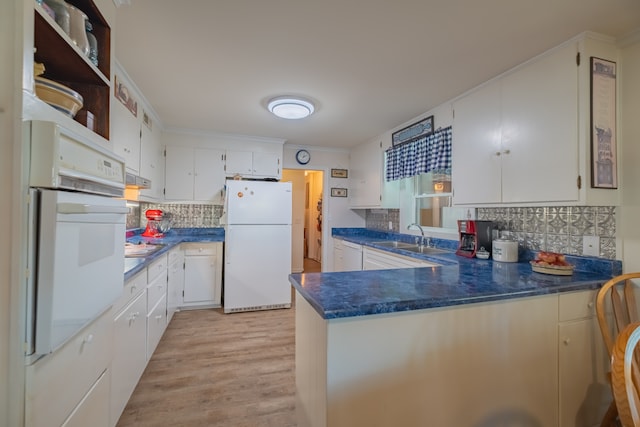 kitchen featuring white cabinets and white appliances