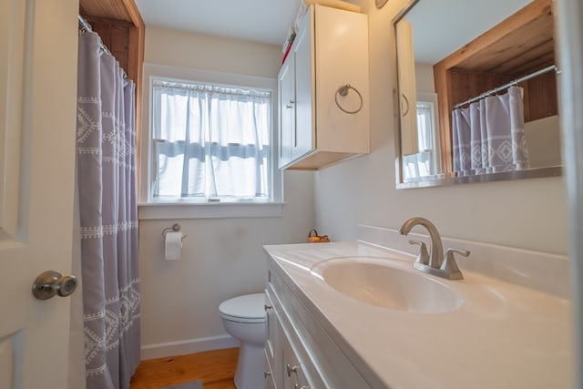 bathroom featuring vanity, hardwood / wood-style floors, and toilet