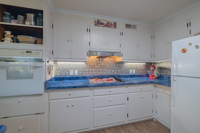 kitchen featuring white appliances, white cabinetry, ornamental molding, and backsplash