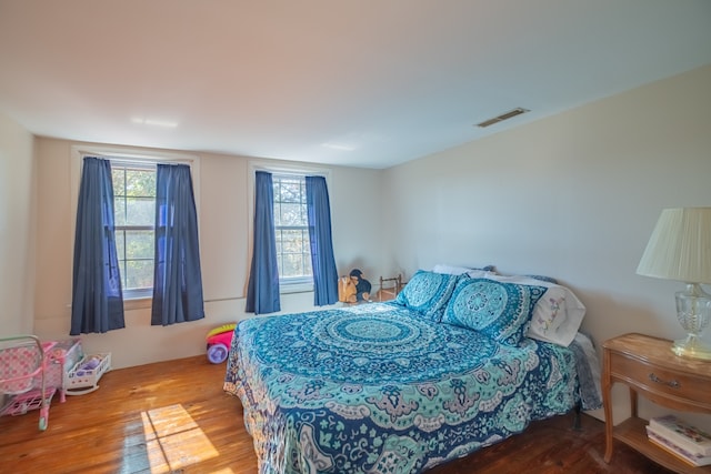 bedroom with hardwood / wood-style flooring