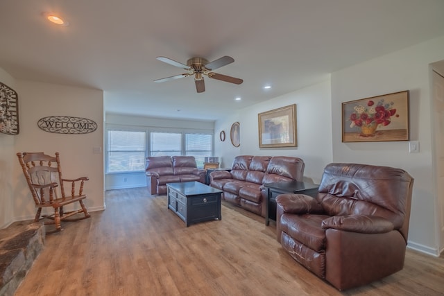 living room with light hardwood / wood-style flooring and ceiling fan