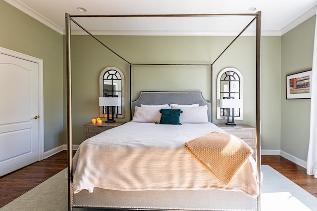 bedroom featuring ornamental molding, baseboards, and wood finished floors