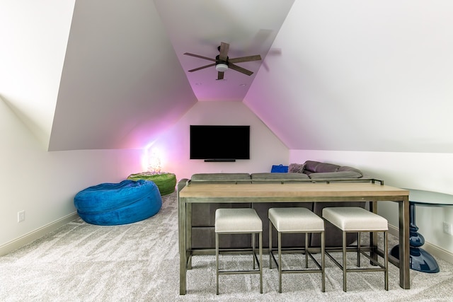 interior space featuring vaulted ceiling, a ceiling fan, and baseboards