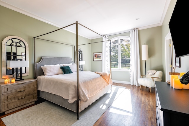 bedroom featuring ornamental molding, dark wood-style flooring, and baseboards