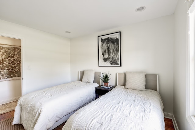 bedroom with baseboards, wood finished floors, and recessed lighting