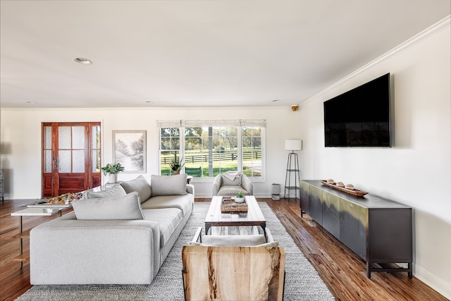 living room with ornamental molding, recessed lighting, wood finished floors, and baseboards