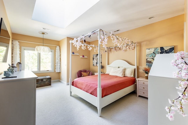 bedroom with a skylight, baseboards, visible vents, and light colored carpet