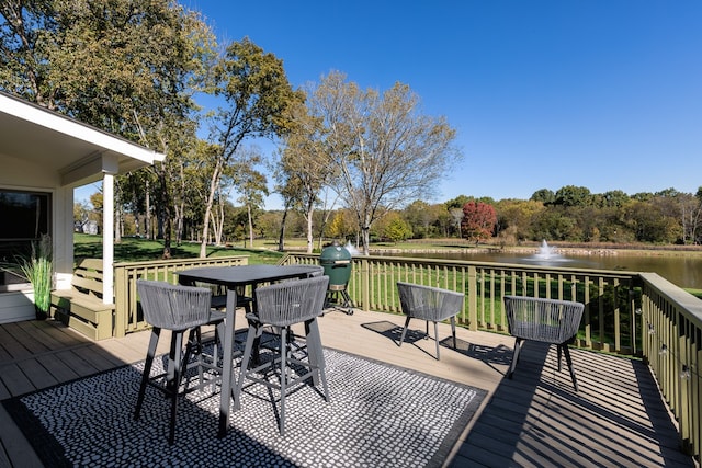 wooden deck featuring outdoor dining space and a water view