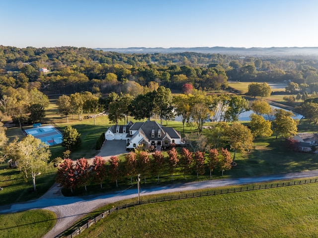 birds eye view of property featuring a water view and a rural view