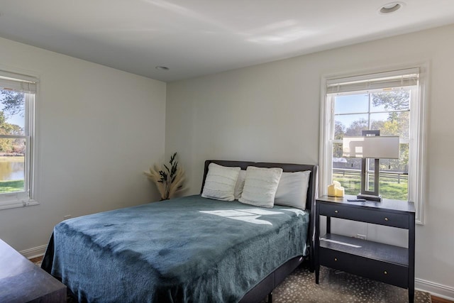 bedroom with multiple windows and baseboards