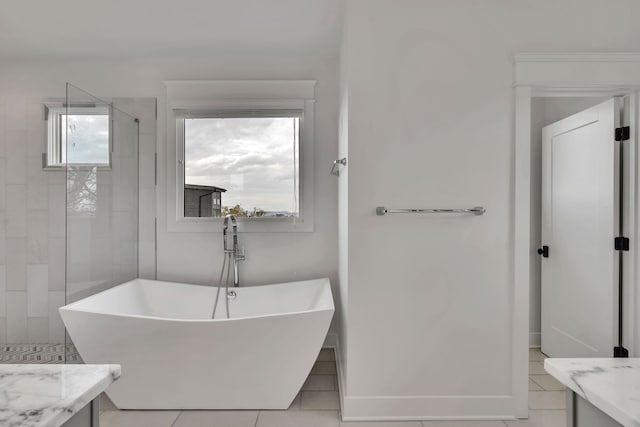 bathroom featuring vanity, a bathtub, and tile patterned floors