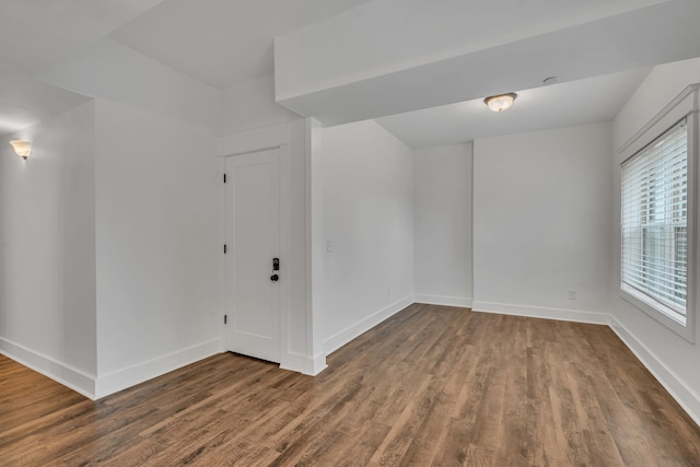 unfurnished room with dark wood-type flooring