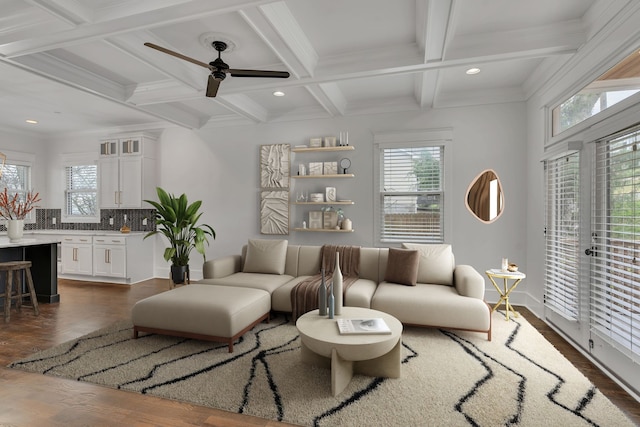 living room featuring beamed ceiling, dark hardwood / wood-style flooring, plenty of natural light, and ceiling fan