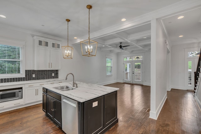 kitchen featuring stainless steel appliances, sink, dark hardwood / wood-style floors, white cabinetry, and an island with sink