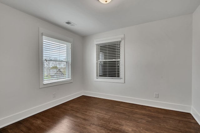 spare room with dark hardwood / wood-style floors