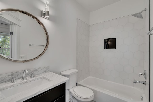 full bathroom featuring vanity, tiled shower / bath combo, and toilet