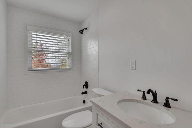 full bathroom featuring vanity, toilet, and tiled shower / bath