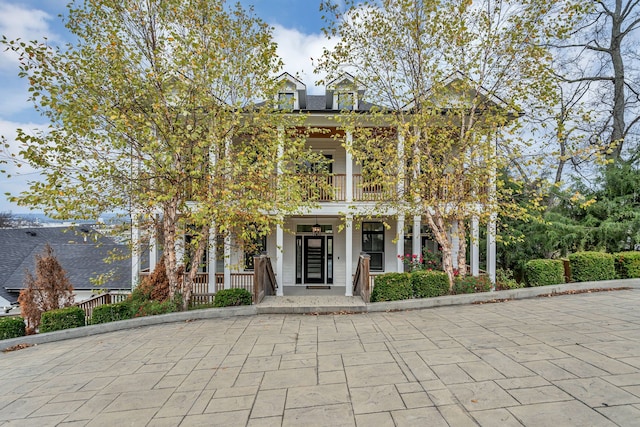 view of front of home with a porch and a balcony