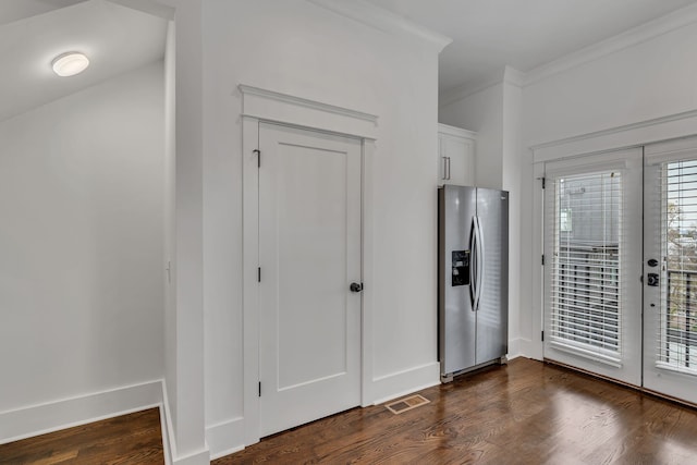 interior space featuring white cabinetry, stainless steel fridge with ice dispenser, dark wood-type flooring, and ornamental molding