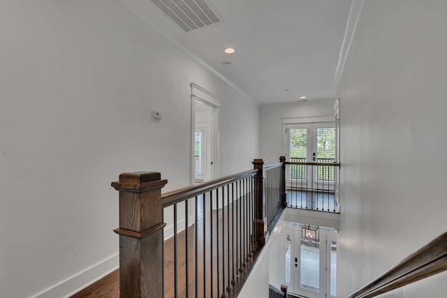 hall featuring ornamental molding, french doors, and dark wood-type flooring