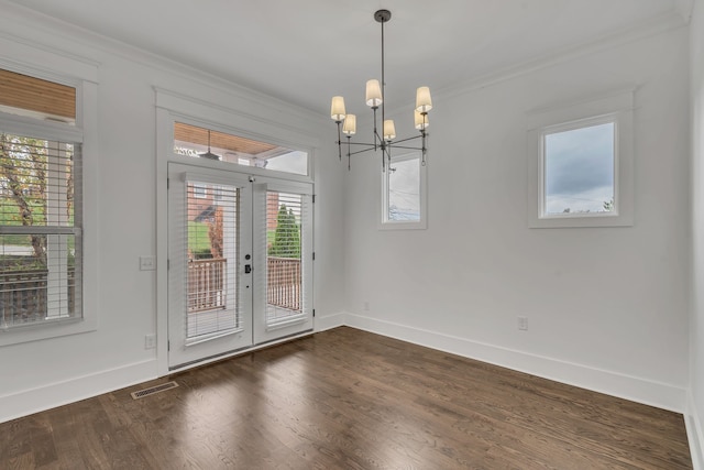 interior space featuring dark hardwood / wood-style flooring, plenty of natural light, ornamental molding, and an inviting chandelier