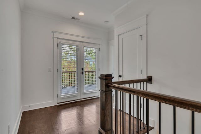 doorway with dark hardwood / wood-style flooring and ornamental molding