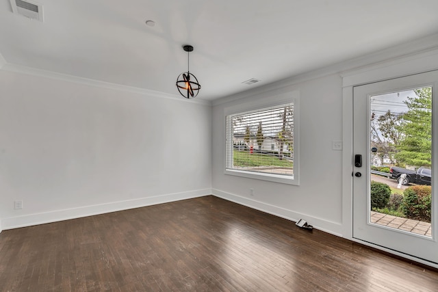 unfurnished dining area with dark wood-type flooring, crown molding, and plenty of natural light