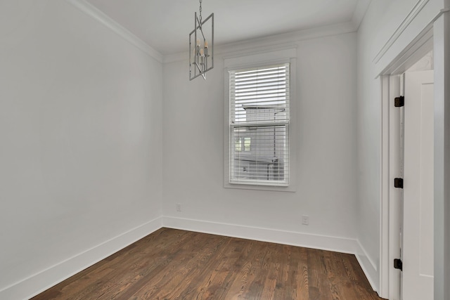 unfurnished room featuring a notable chandelier, crown molding, and dark hardwood / wood-style flooring