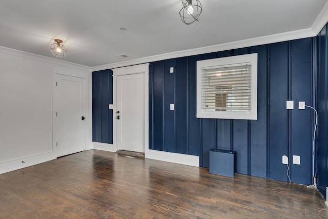 entrance foyer featuring dark hardwood / wood-style flooring and ornamental molding