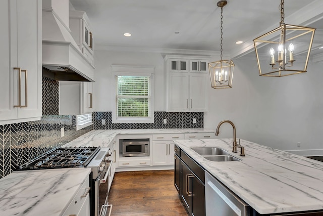 kitchen with white cabinetry, sink, decorative light fixtures, a center island with sink, and appliances with stainless steel finishes