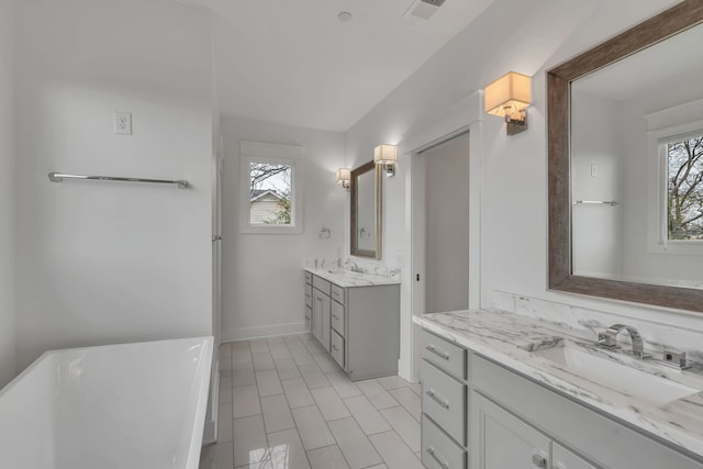 bathroom with vanity and a tub to relax in