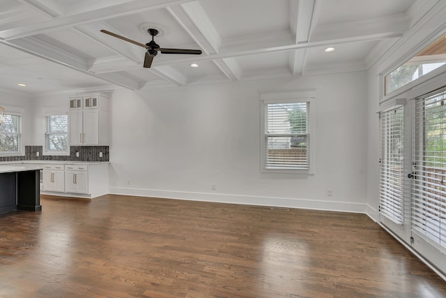 unfurnished living room with dark wood-type flooring and a healthy amount of sunlight