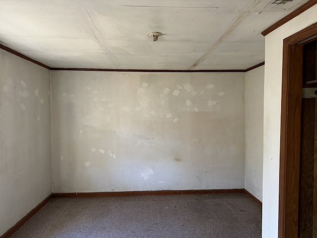 carpeted spare room with crown molding