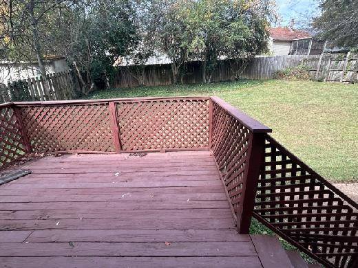 wooden terrace featuring a yard